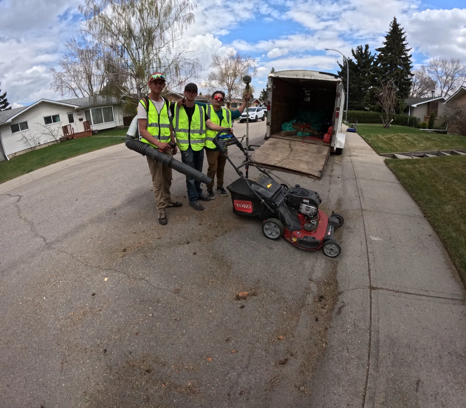 Somerset crew with mowing and trimming equipment on a Calgary job